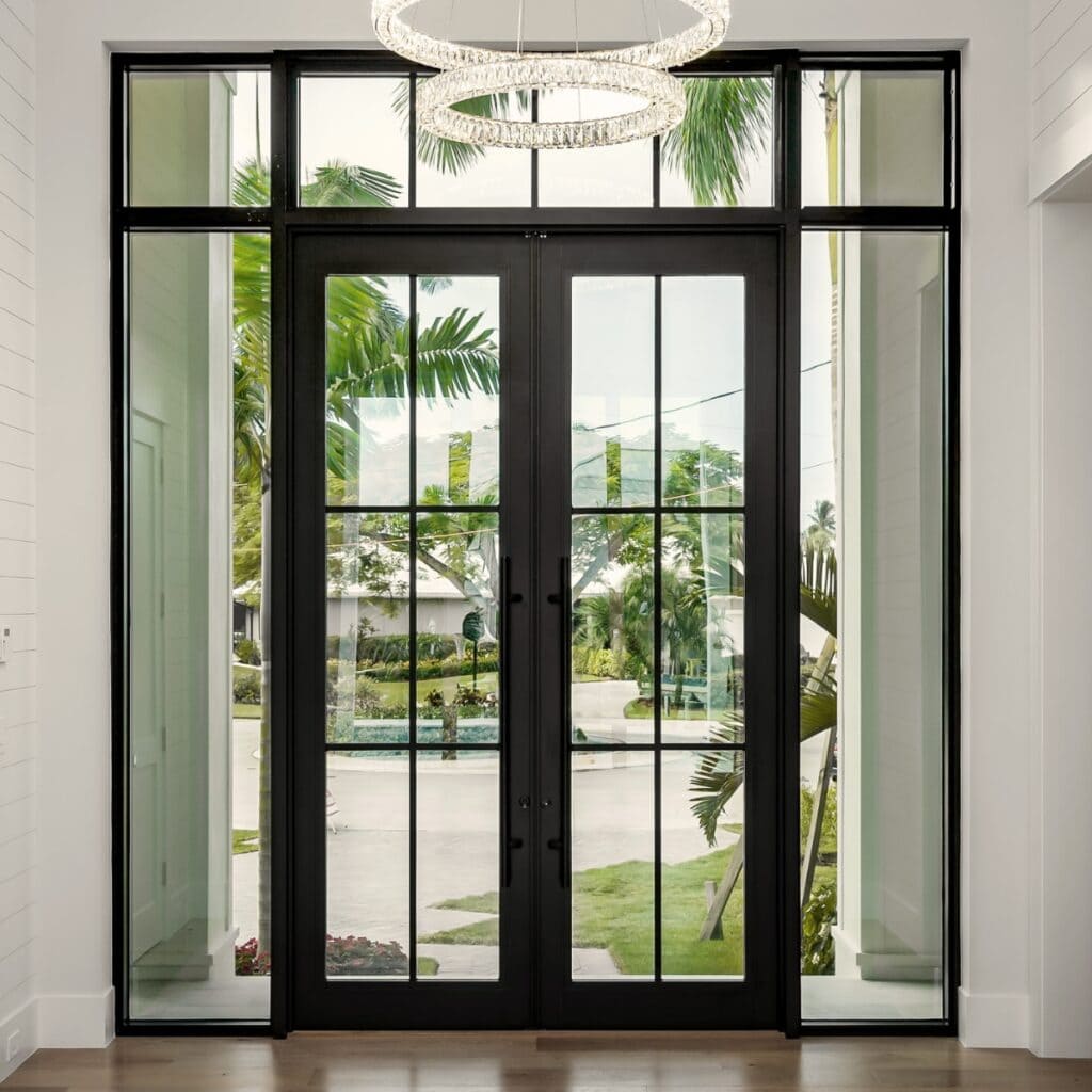 A closed glass double door leading to an outside area with a pool.