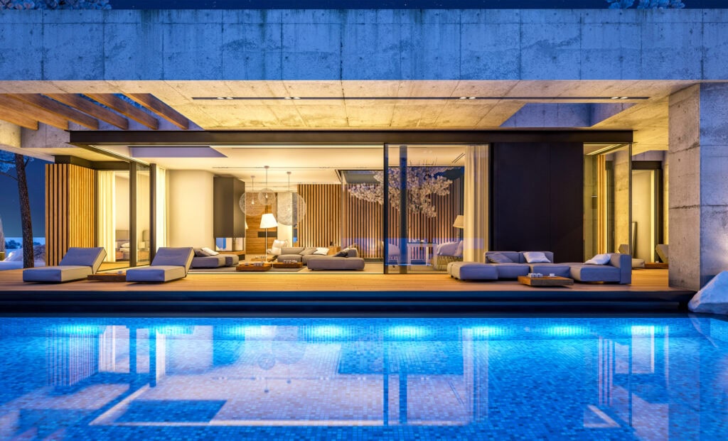 Extra Large glass windows and sliding glass doors opening up to an outdoor pool