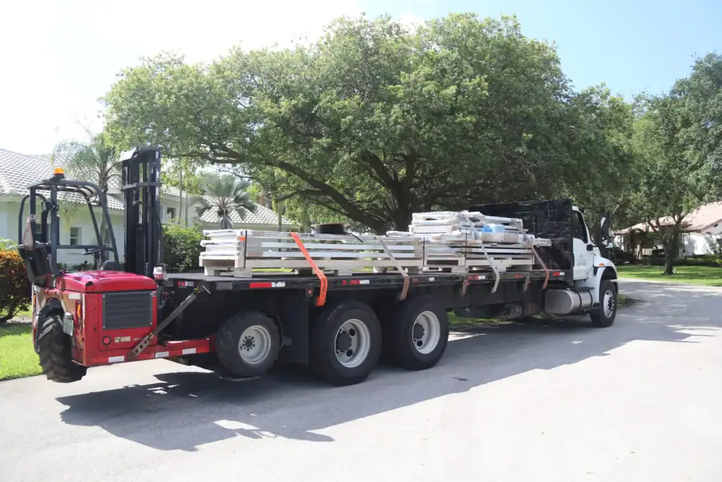 large flat bed truck carrying windows