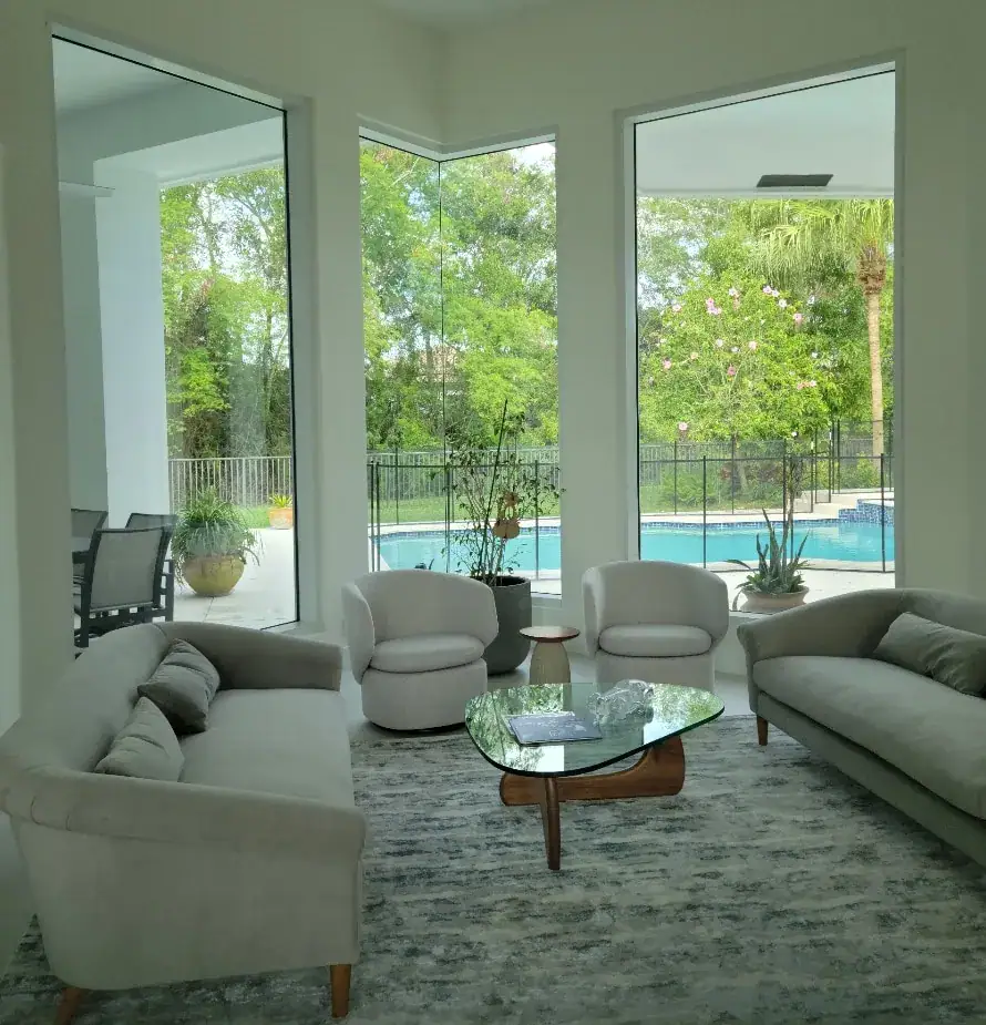 sitting room with full length windows overlooking pool