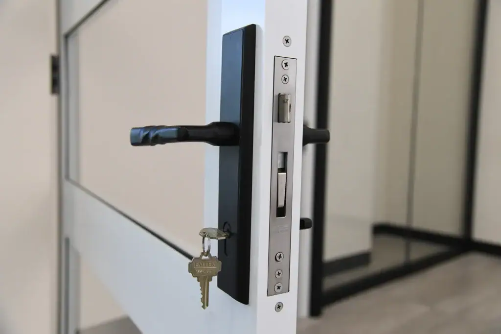 key sitting in a matte black doorknob keyhole