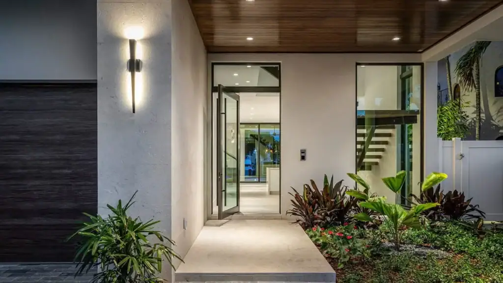 showcasing a pivot door at dusk on an elegant home